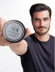 Model holding Grooming Cream Puck
