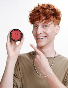 Model holding Cream Pomade Puck